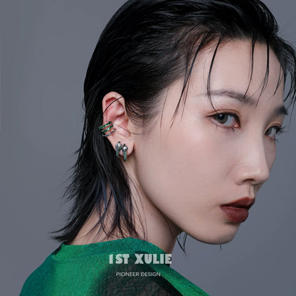 Slytherin snake earrings featured on a model with a stylish haircut and bold makeup