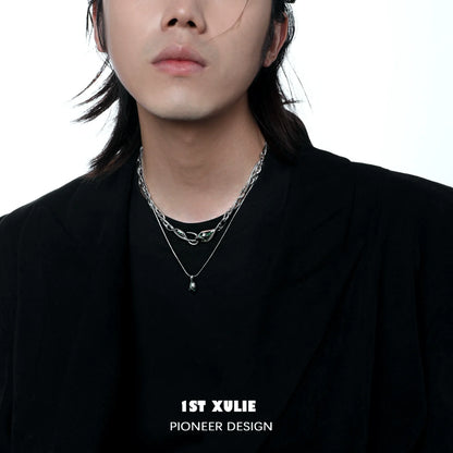 Stylish Slytherin snake necklace worn layered with silver chains for a trendy look