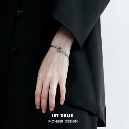 Stylish Slytherin snake silver bracelet worn on a hand, perfect for fans of the Harry Potter series