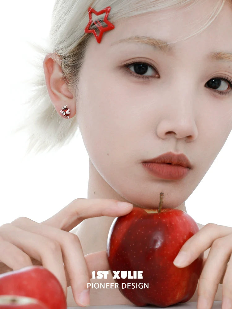 Model wearing snake apple earrings with red apples for a trendy and stylish look