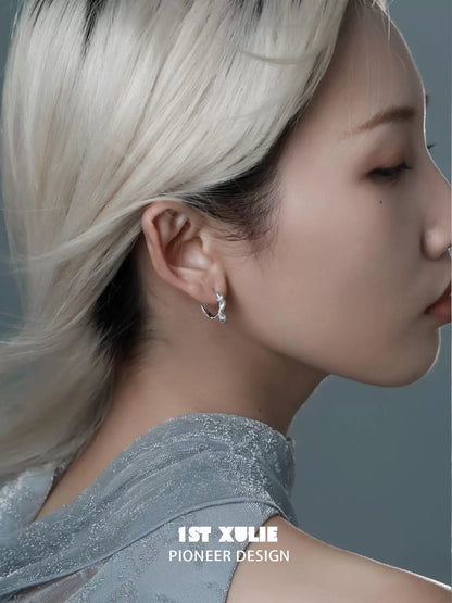 Stylish snake hoop earrings silver showcased on a model with light blonde hair