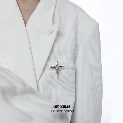 Elegant starry silver brooch on a white suit jacket, adding a touch of sophistication