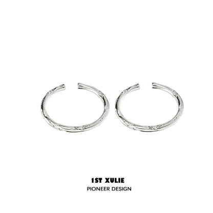 Textured silver ring from 1STXULIE showcases a unique design with intricate detailing