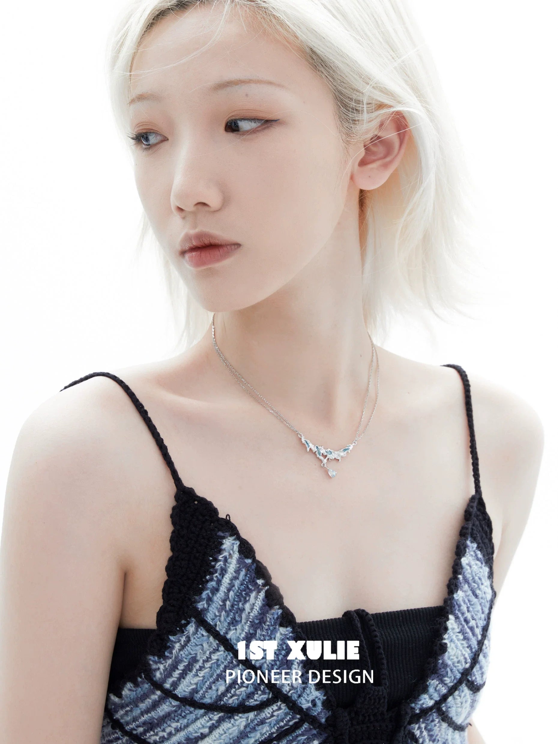 Unique silver sea necklace displayed on a model with short blonde hair, highlighting elegant design