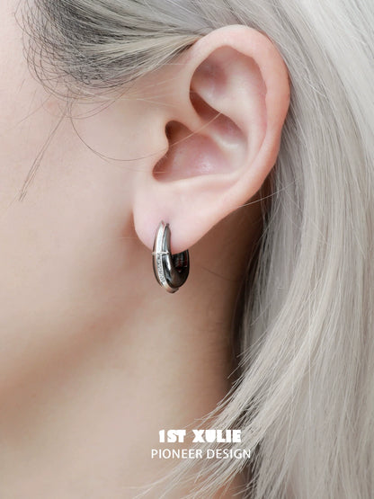 Stylish urban edge hoop earrings showcased on a model with light hair, perfect for modern fashion lovers.