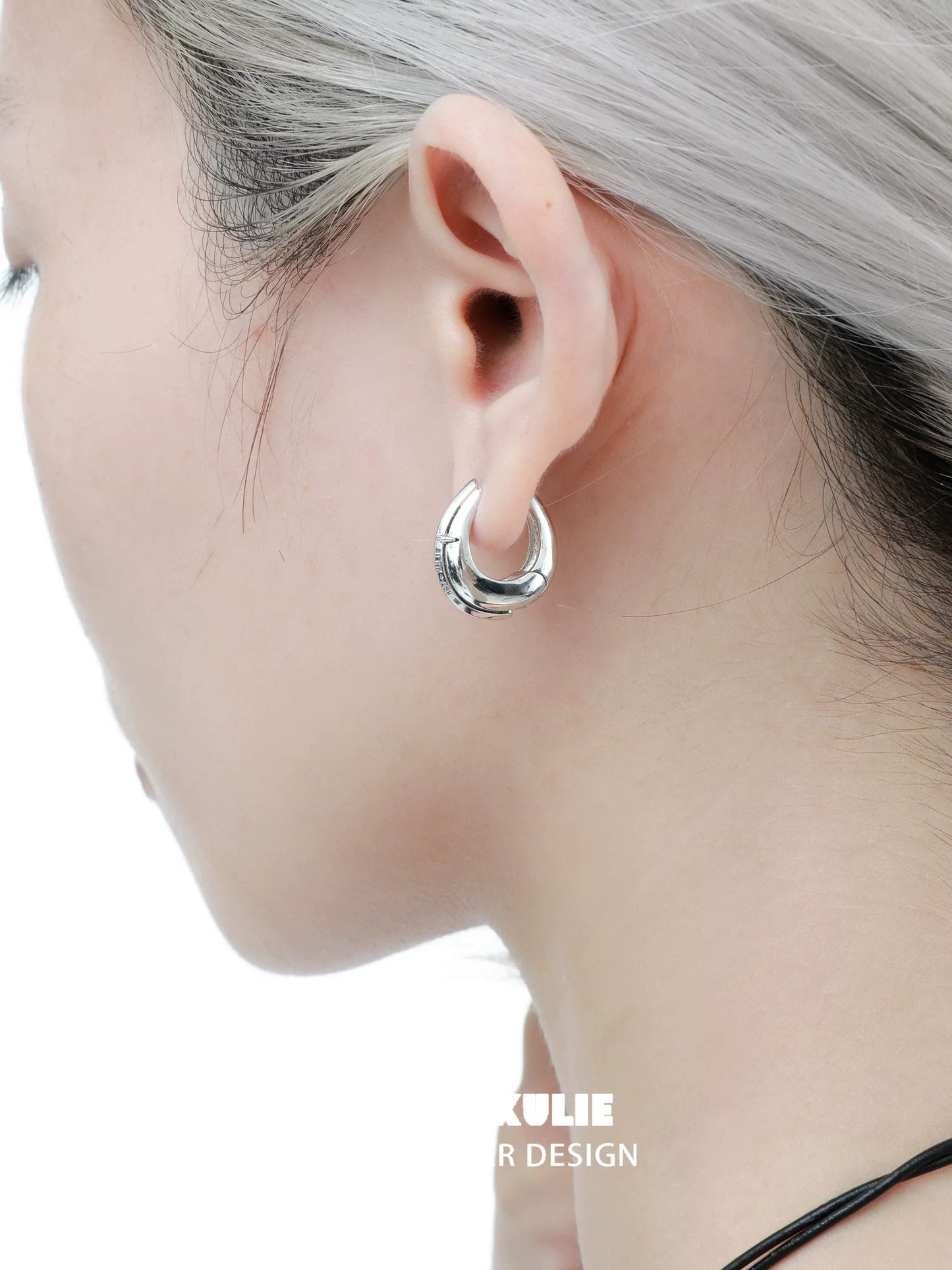 Elegant 1STXULIE urban edge hoop earrings showcasing a sleek and modern design on a model's ear