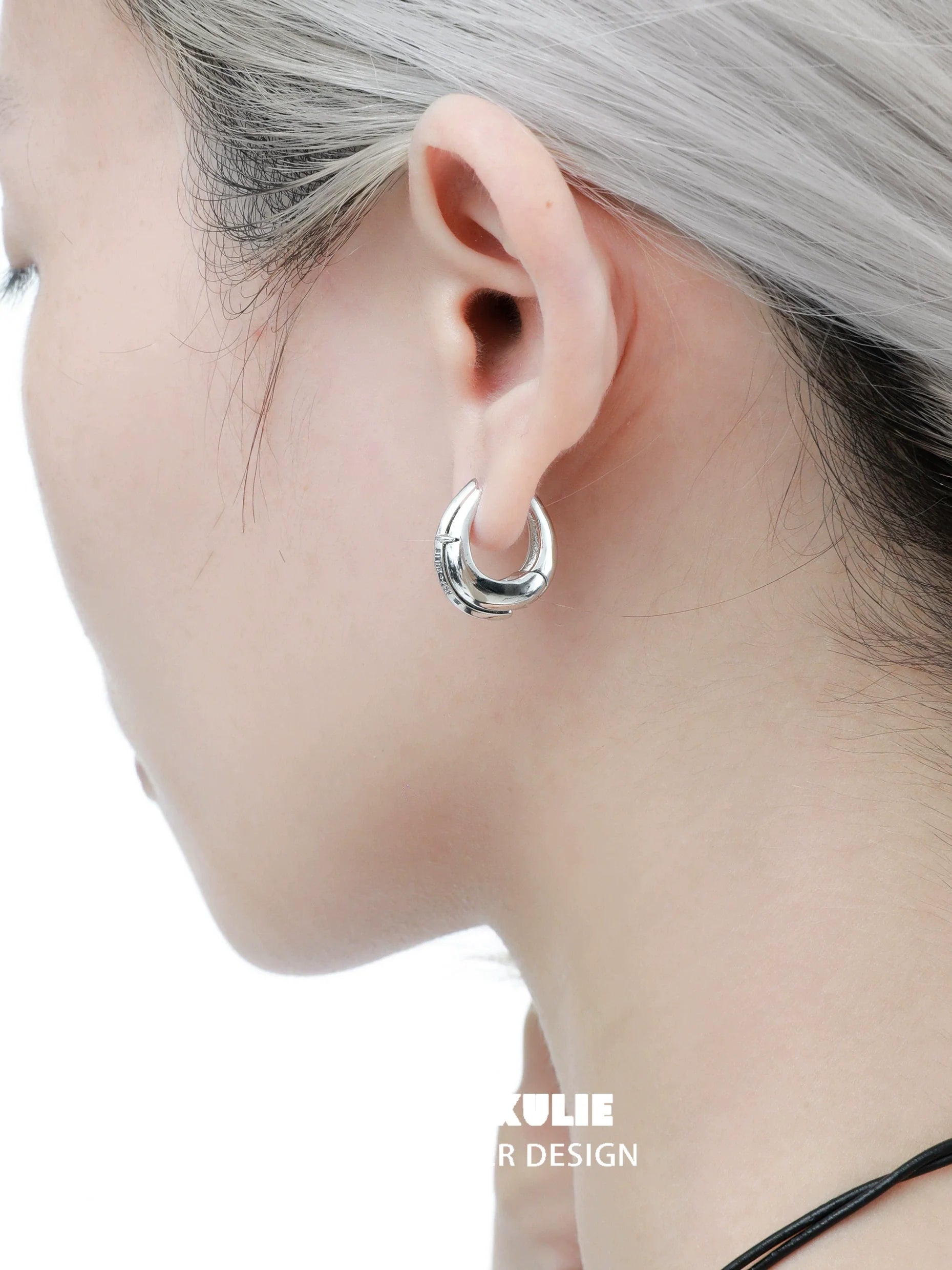 Elegant 1STXULIE urban edge hoop earrings showcasing a sleek and modern design on a model's ear