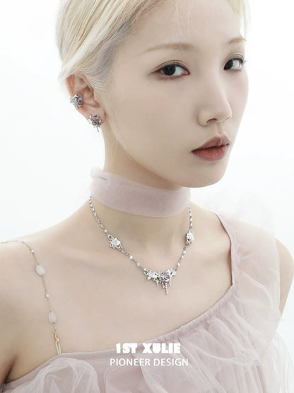 Elegant model wearing velvet rose stud earrings paired with a stylish choker and silver necklace