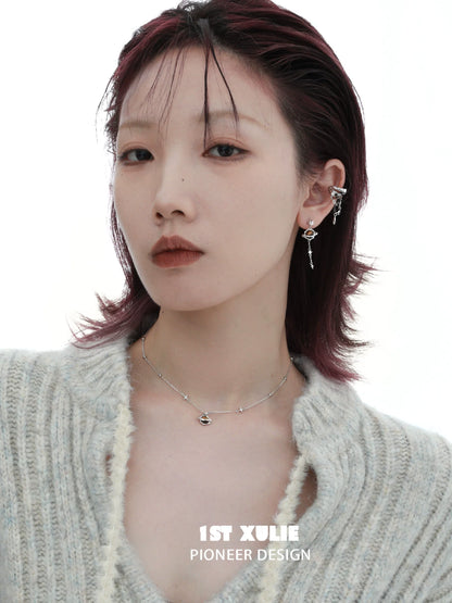 Stylish model wearing wasteland ear cuff earrings with a unique design and a chic hairstyle