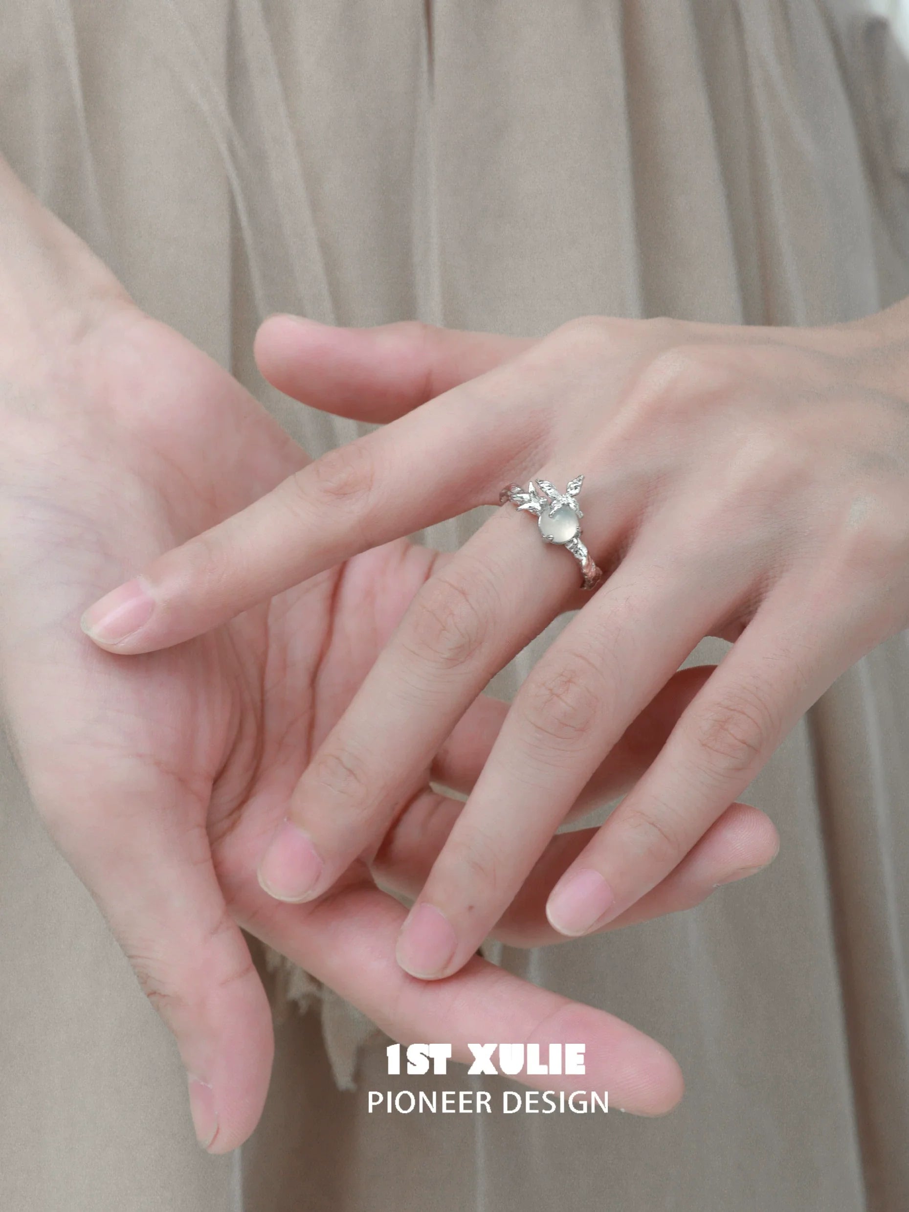 Elegant white agate butterfly silver ring featured on a model's hand with delicate design