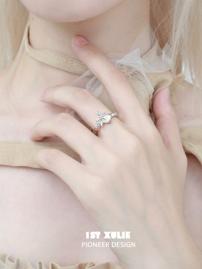 Beautiful white agate butterfly silver ring worn elegantly on a hand with a delicate outfit