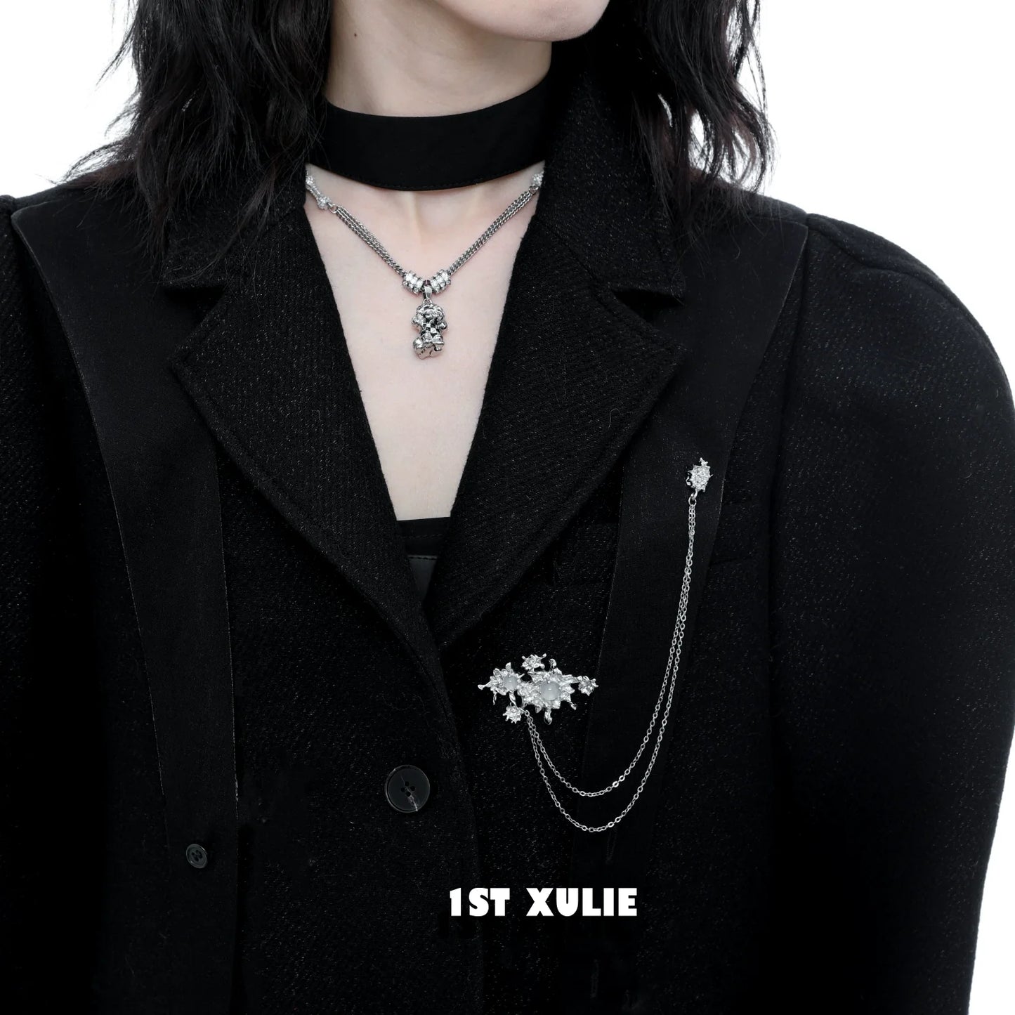 Elegant white agate chain brooch on a stylish black coat for a chic look