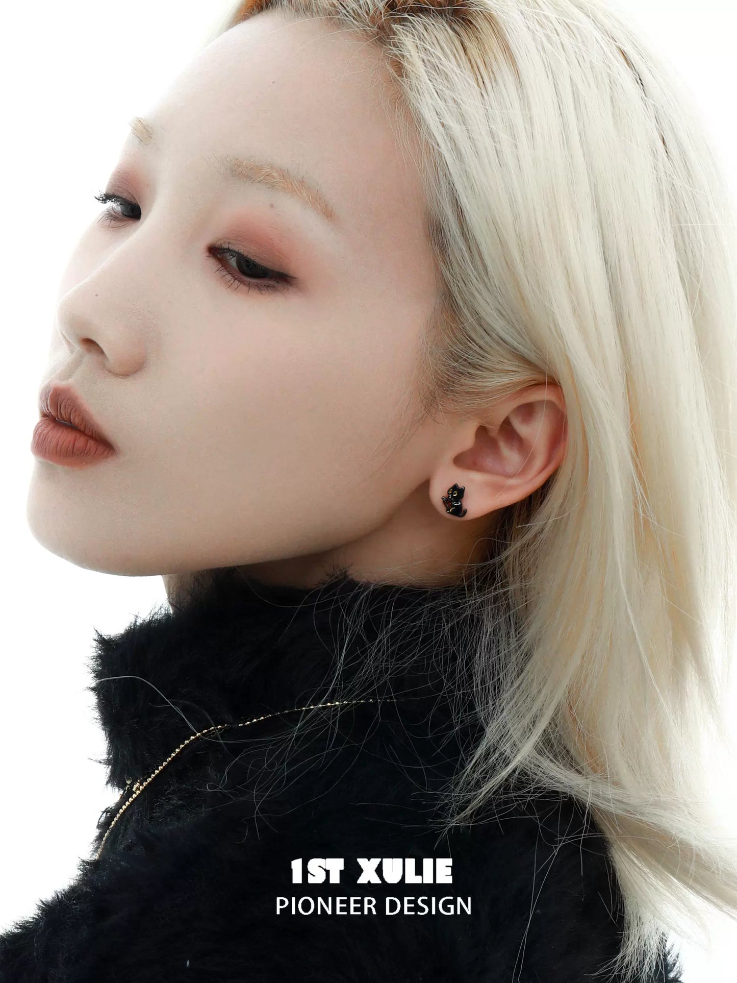 Model wearing Y2K black cat earrings with a sleek hairstyle and stylish outfit