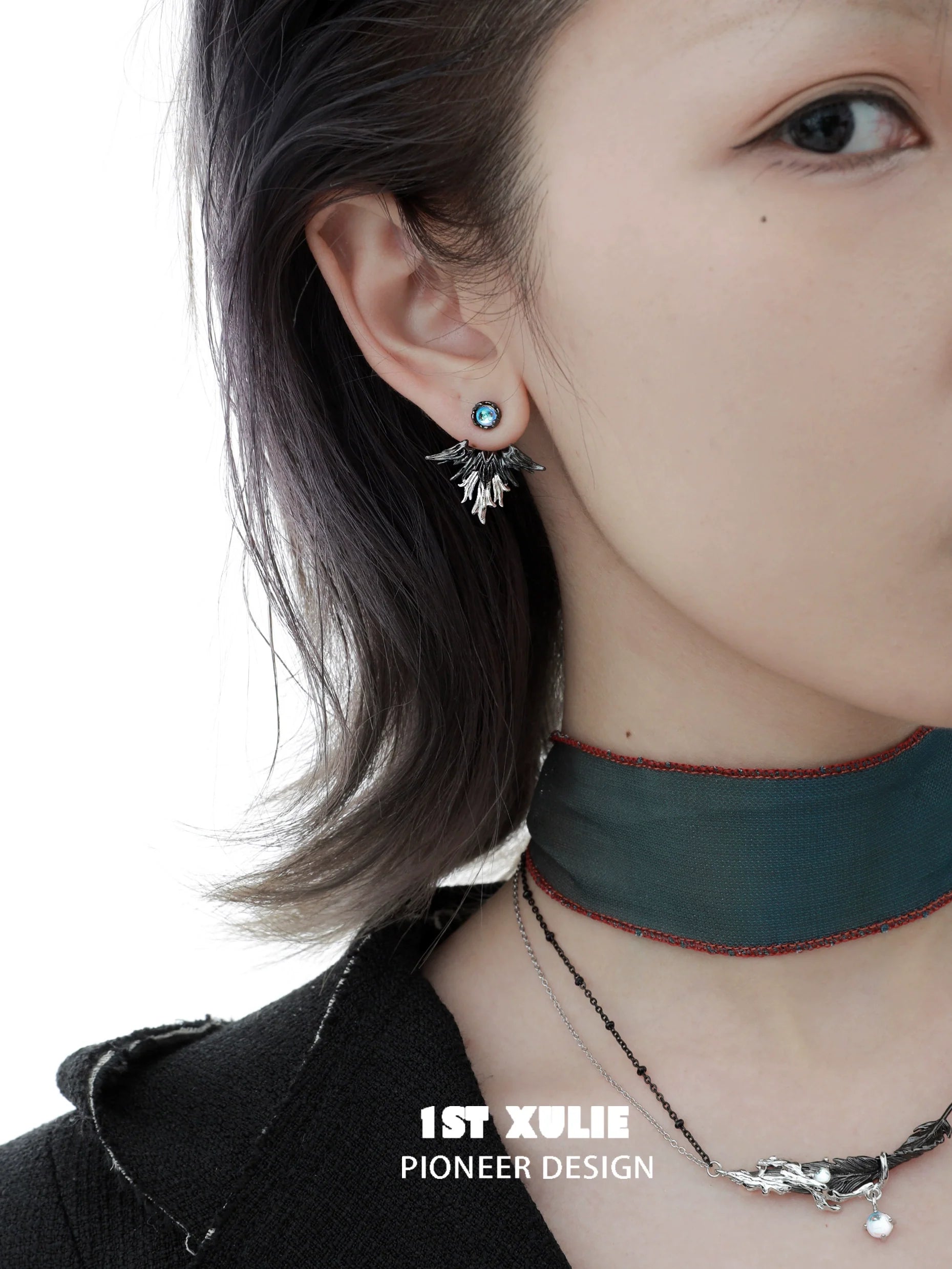 Model wearing Y2K devil wing earrings paired with layered necklaces for a trendy look