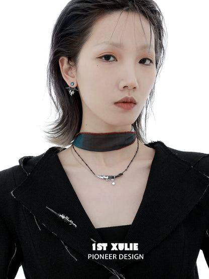 Y2K devil wing earrings showcased on a model with an edgy black outfit and choker