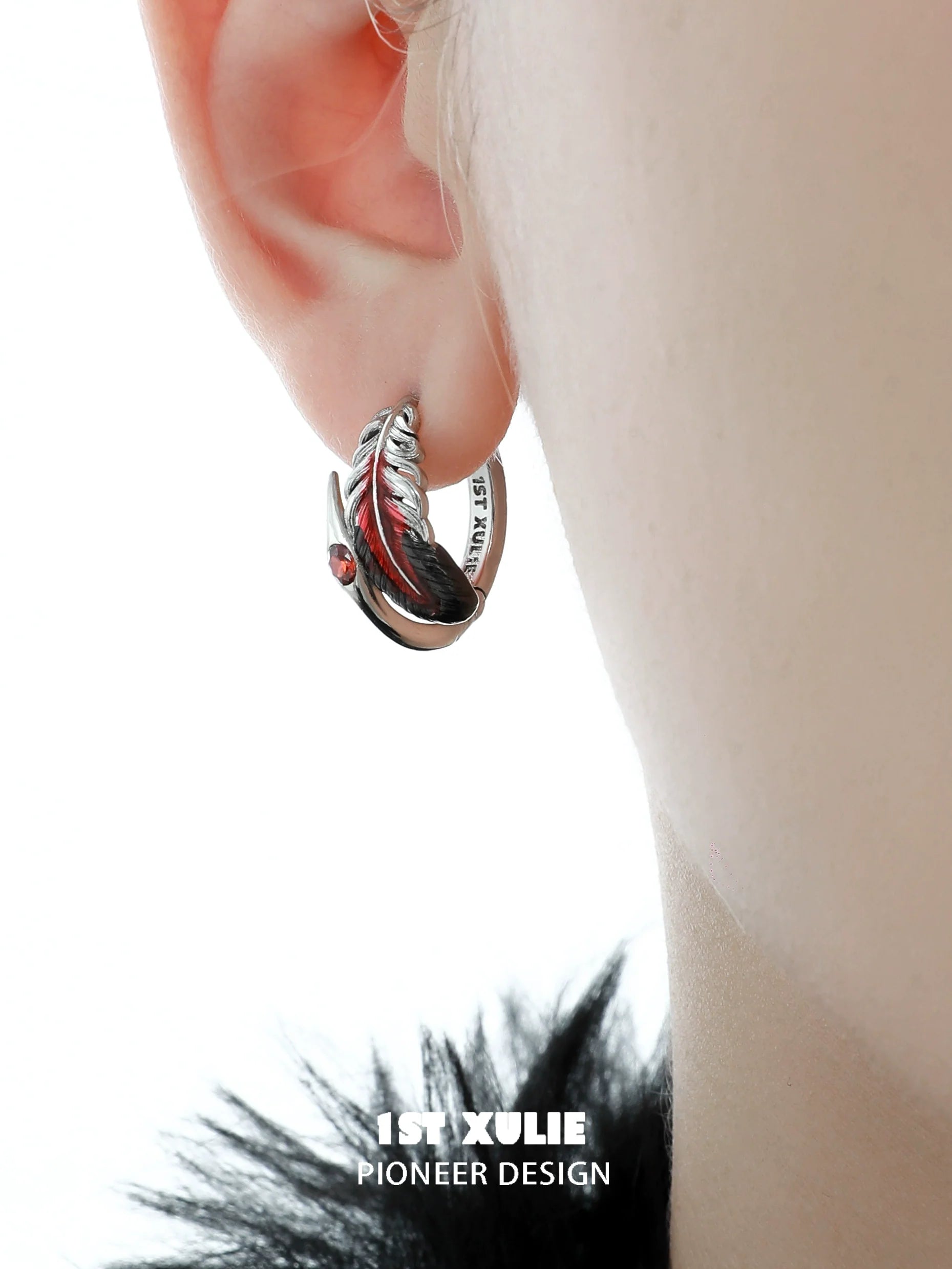 Y2K feather earrings by 1STXULIE featuring a sleek silver design and a pop of red gemstone
