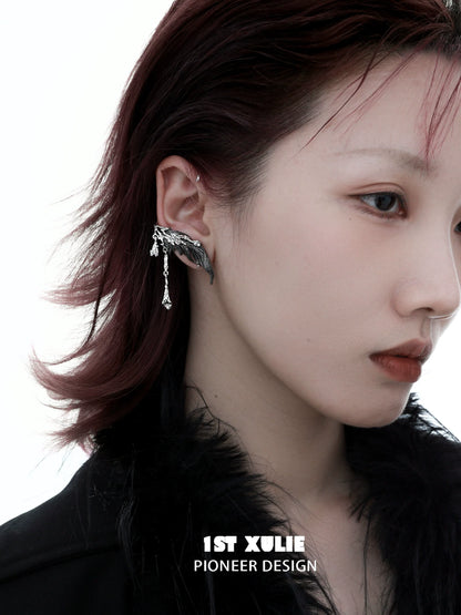 Y2K feather tassel earrings showcased on a model with a chic hairstyle and makeup