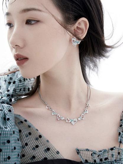 Model wearing y2k melting love earrings and matching necklace with a stylish outfit