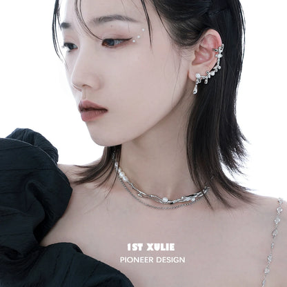 Fashion model wearing a Y2K pearl choker necklace layered with delicate chains for a trendy look