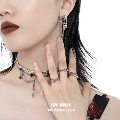 Y2K post-apocalyptic earrings featuring chains and red details, styled with edgy fashion accessories