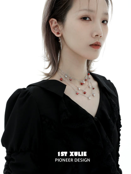 Model wearing Y2K rose silver earrings with layered necklaces for a stylish look