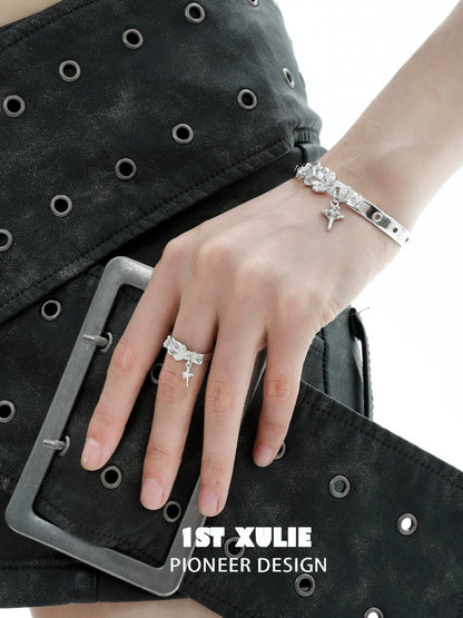 Y2K silver belt bracelet featuring unique charms, stylishly worn on a hand with a ring