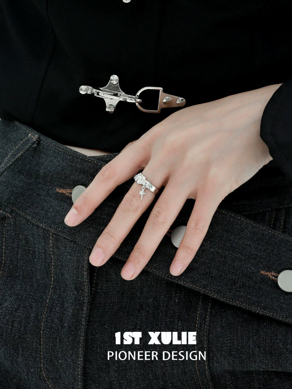Y2K silver belt buckle ring worn on the hand, styled with a fashionable outfit