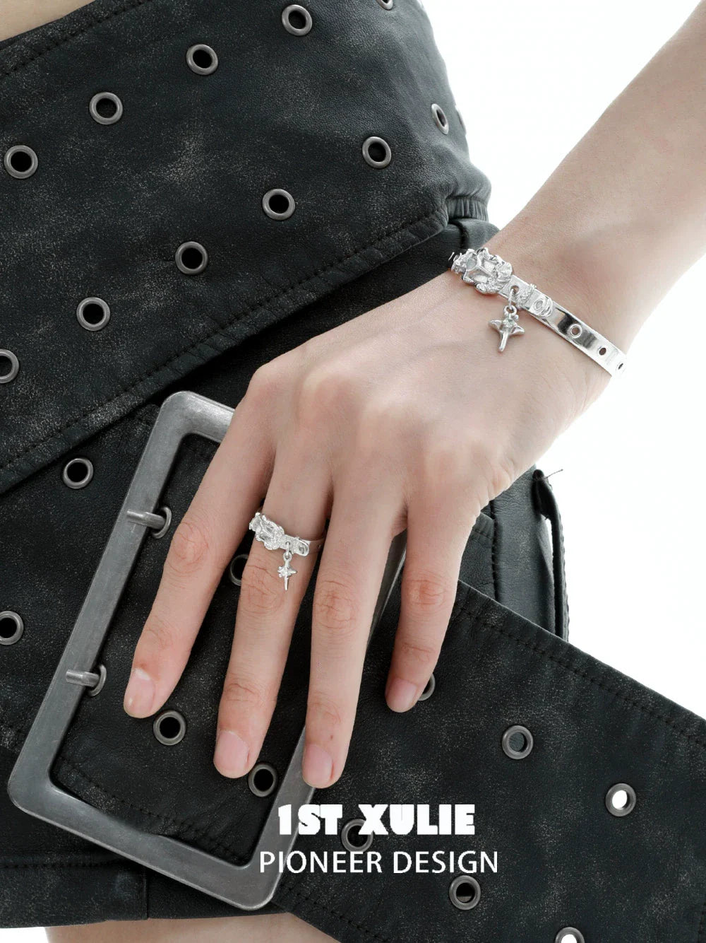 Fashionable Y2K silver belt buckle ring worn on hand with stylish black skirt
