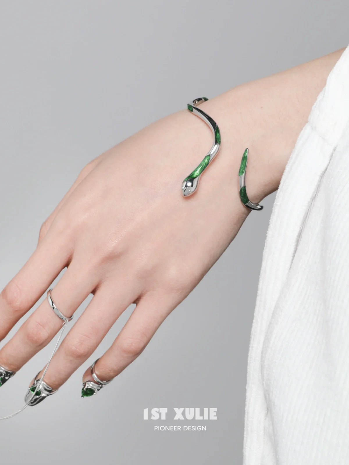 Y2K Slytherin snake bracelet in silver and green design worn on a hand with stylish nails