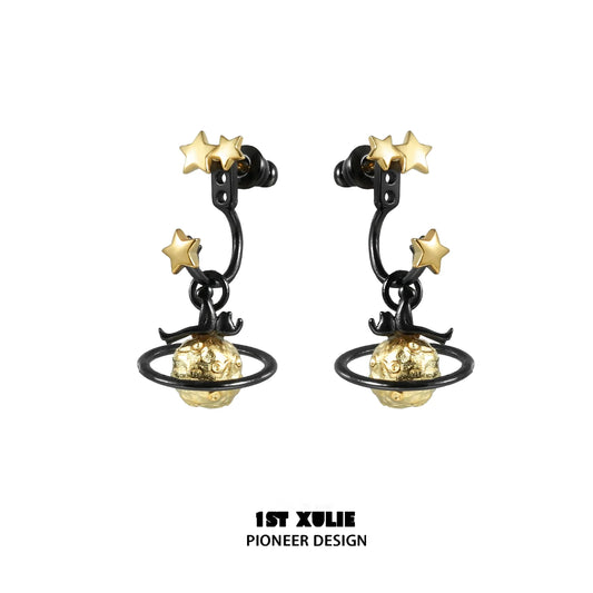 Y2K star earrings featuring gold stars and planet design on black metal hoops
