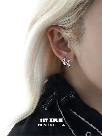Y2K starpunk thorn earrings in silver design showcased on a model's ear for a trendy look