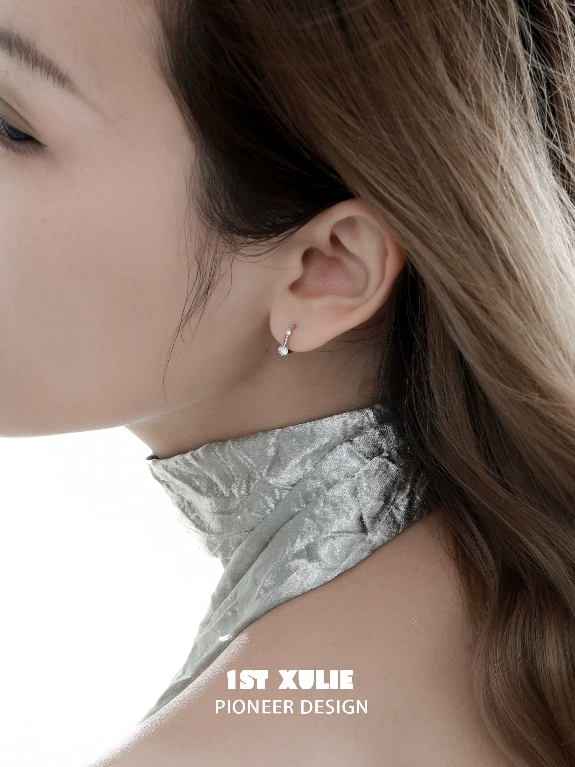Elegant 1STXULIE zircon stud earrings for women displayed on a model's ear