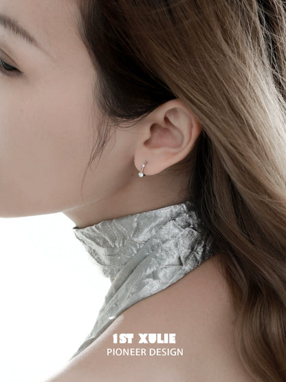 Elegant 1STXULIE zircon stud earrings for women displayed on a model's ear