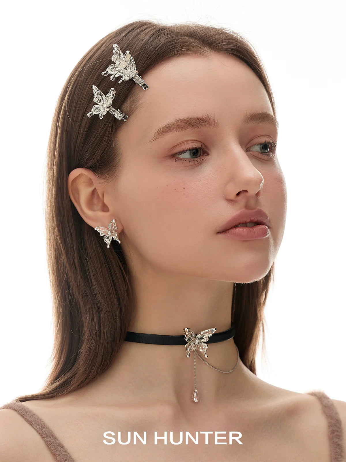 Elegant model wearing SUN HUNTER 3D butterfly earrings with matching accessories for a stylish look