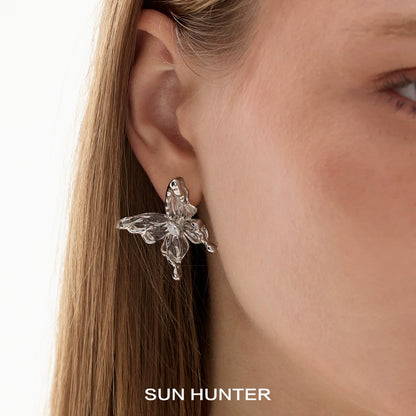 Elegant SUN HUNTER 3D butterfly earrings featuring intricate design and shimmering details