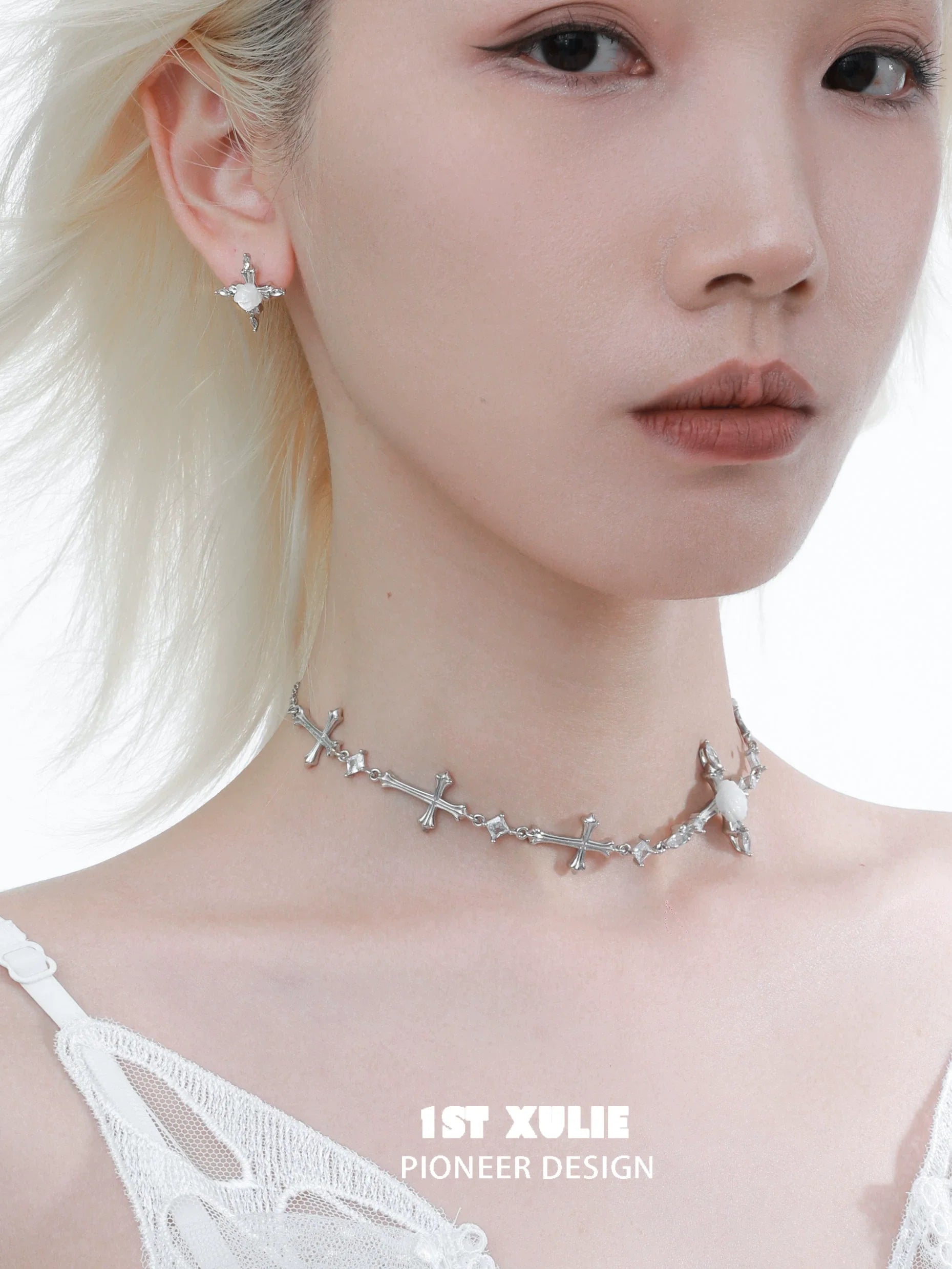 Elegant silver rose cross necklace paired with matching earrings for a stylish look