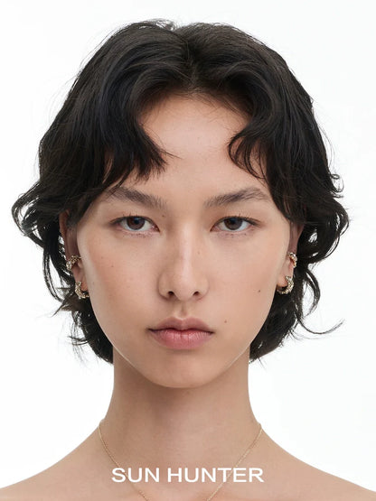 Model wearing a vintage iris ear cuff from SUN HUNTER showcasing a unique design