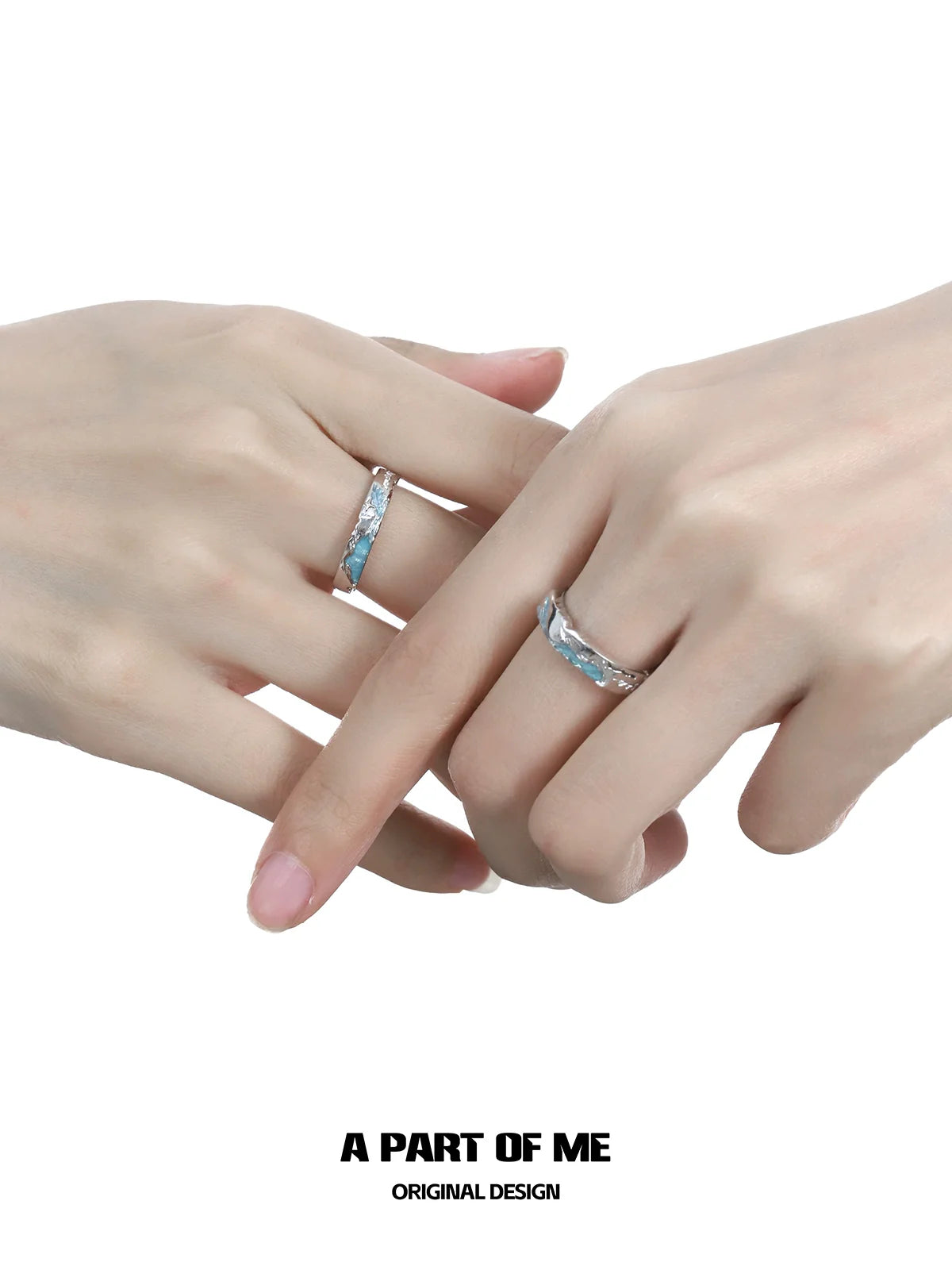 A pair of hands wearing the A PART OF ME azure dream fish ring featuring a sleek design