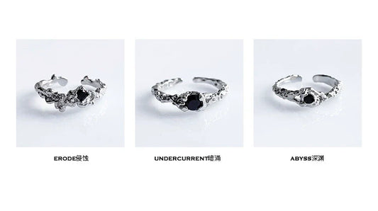 A black crown ring featuring intricate detailing and a central black gemstone for a unique style