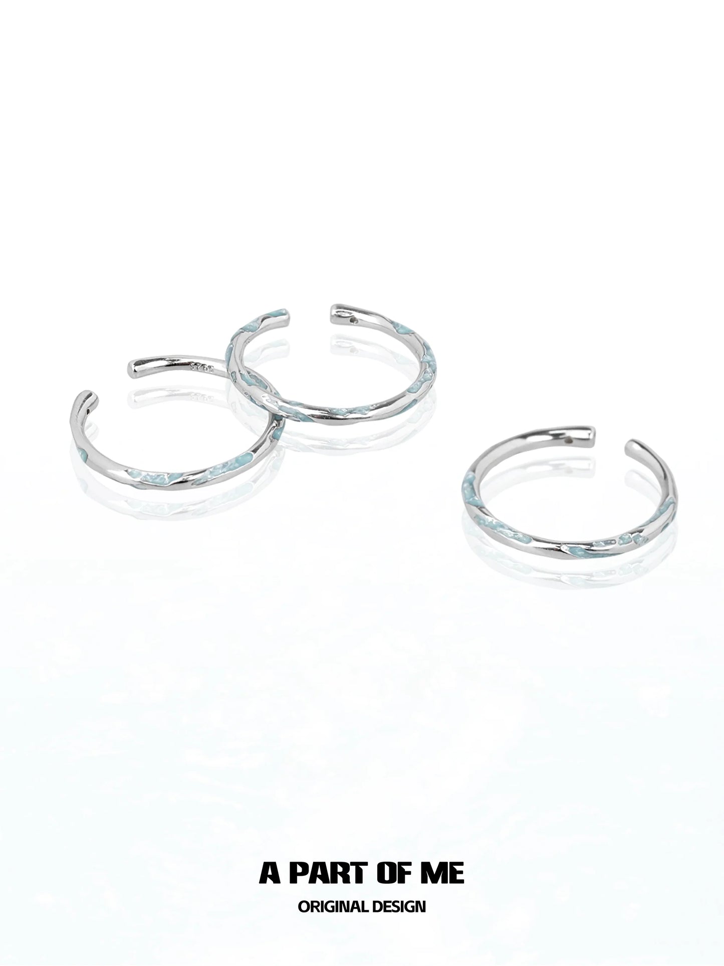Set of three A PART OF ME blue minimalist ring designs with a sleek silver finish