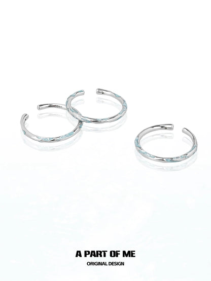 Set of three A PART OF ME blue minimalist ring designs with a sleek silver finish
