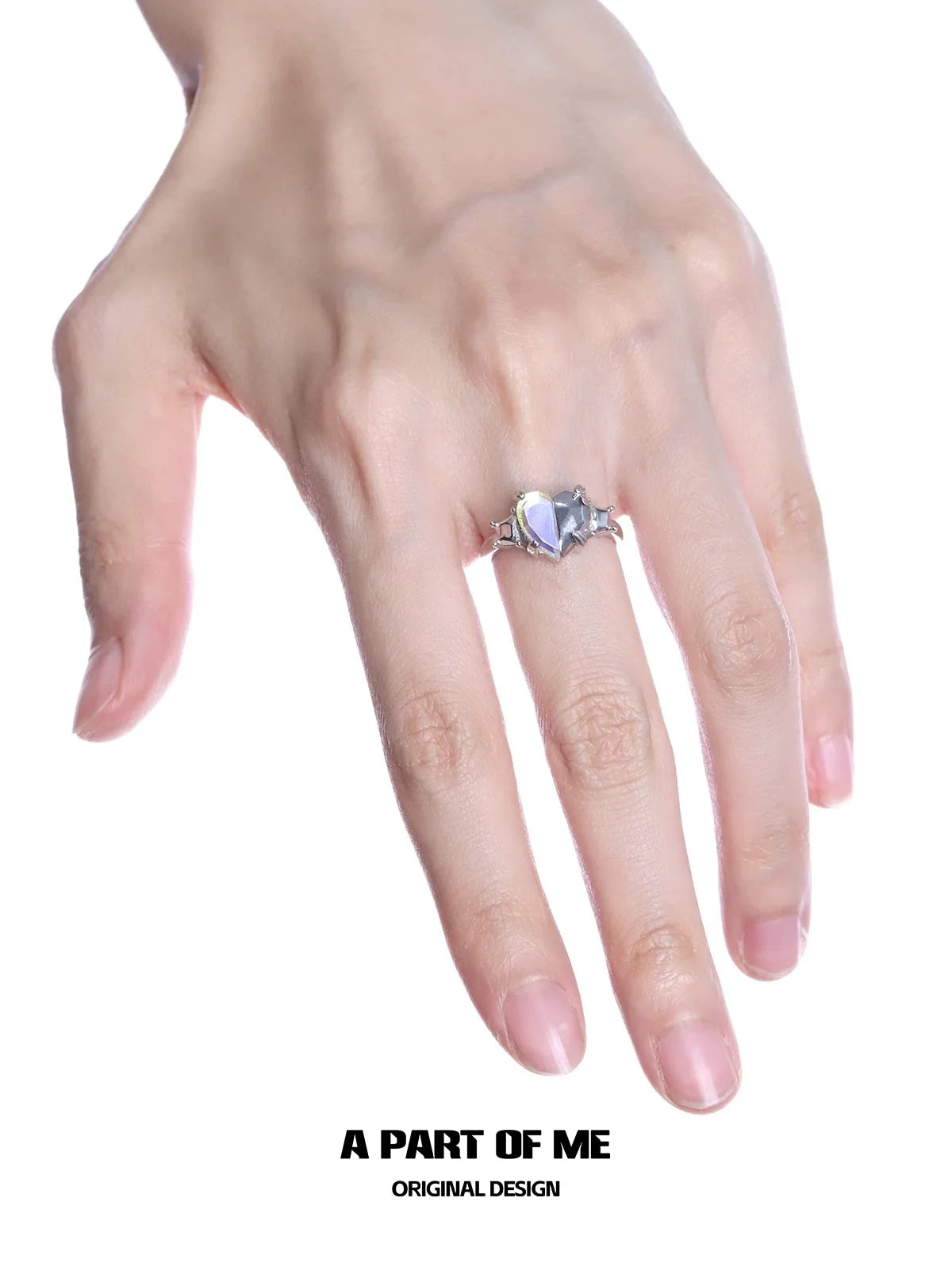 A hand displaying a color changing armor ring from A PART OF ME with a unique design
