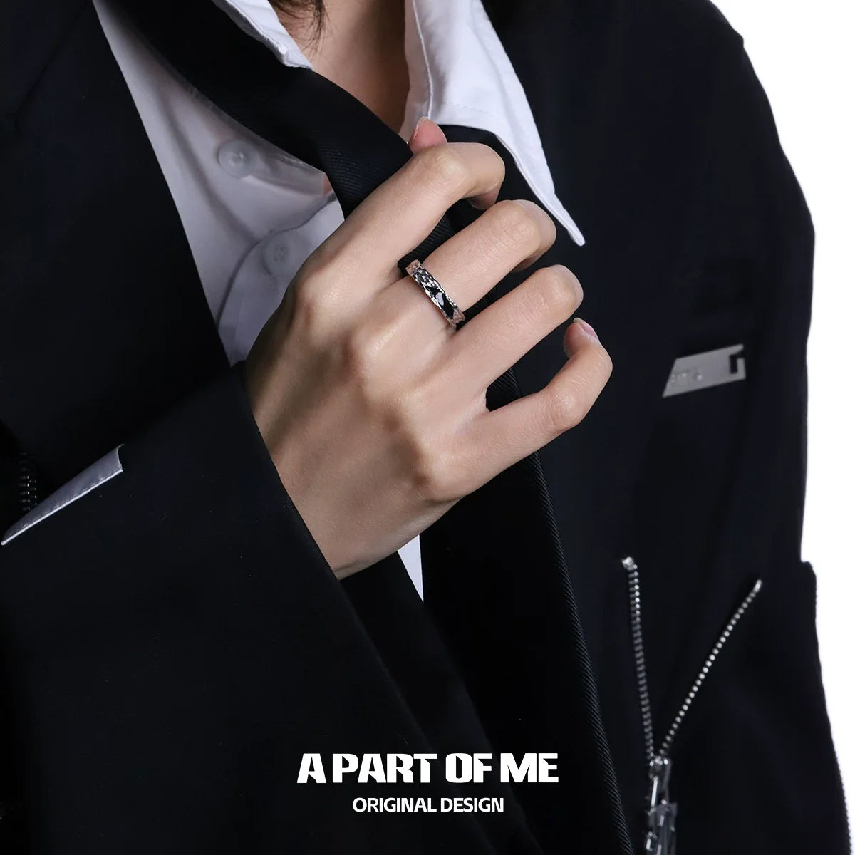 Stylish A PART OF ME dark hills ring worn on a hand with a formal black suit and white shirt