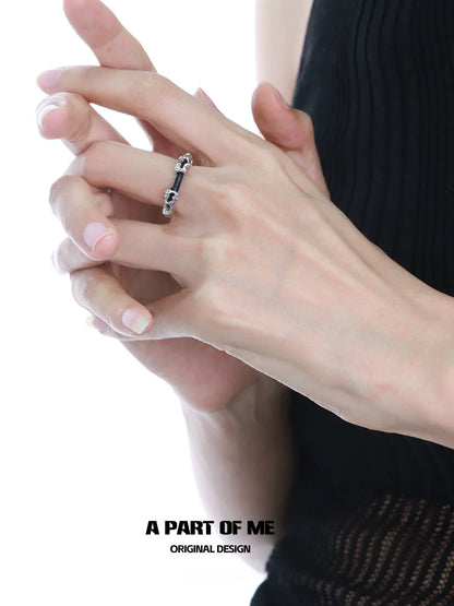 Elegant A PART OF ME dark matter ring showcased on a model's hand with natural nails