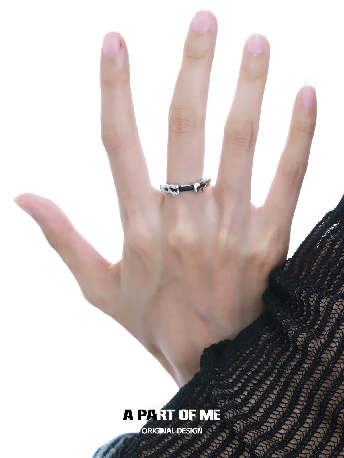 A PART OF ME Dark Matter Ring showcased on a model's hand with intricate design details