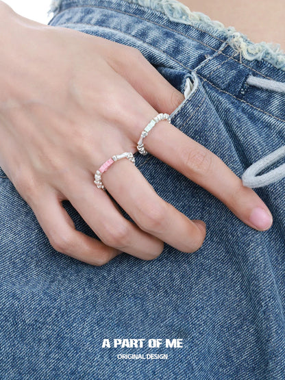 Two A PART OF ME dopamine rings stacked on a hand with denim shorts for a trendy look