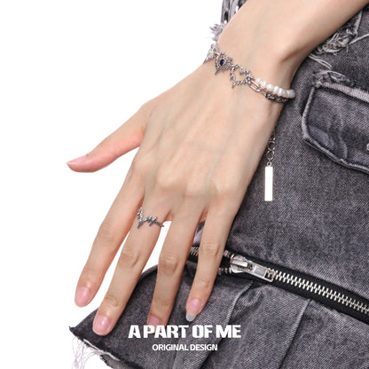 Electrocardiogram wave silver ring on a model's hand with stylish denim outfit