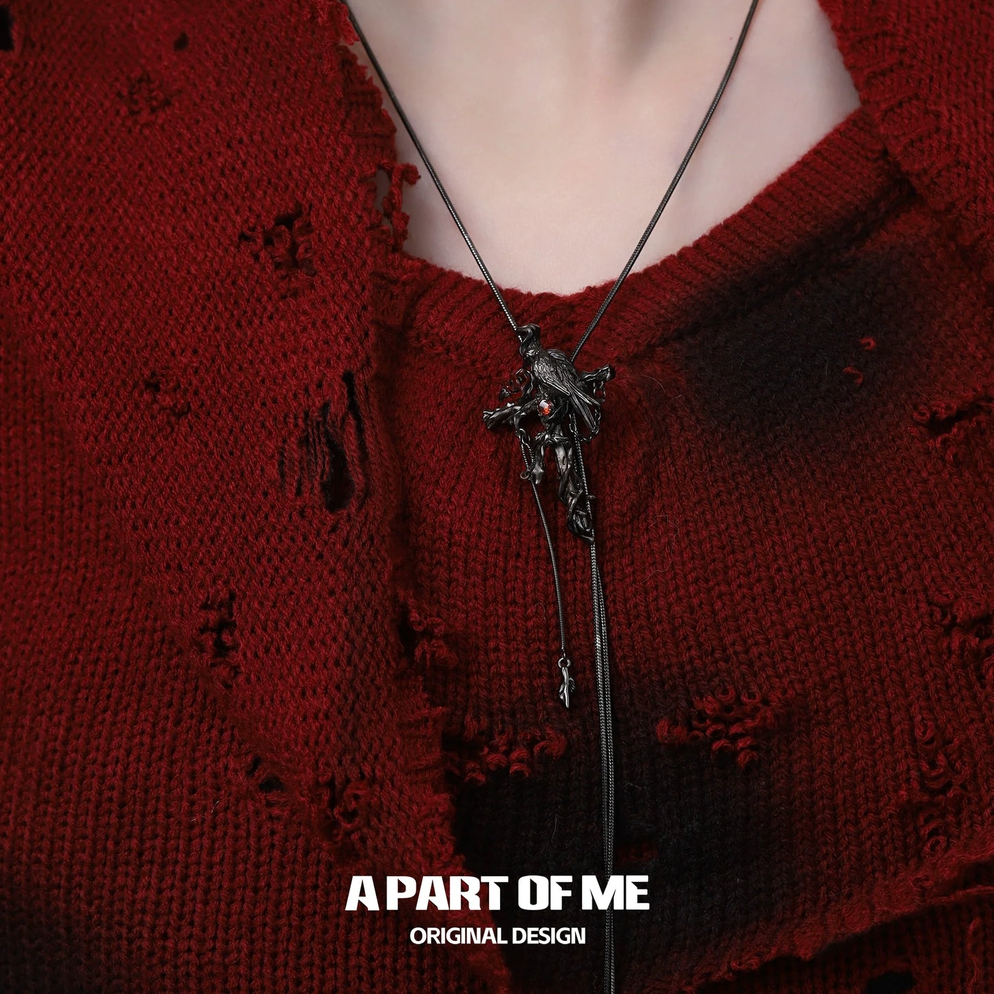 A PART OF ME gothic crow cross necklace with detailed pendant on a dark outfit