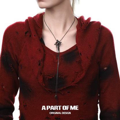 Gothic crow cross necklace displayed on a model wearing a red distressed sweater