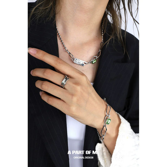 A PART OF ME green crown punk ring showcased on a stylish hand with silver jewelry